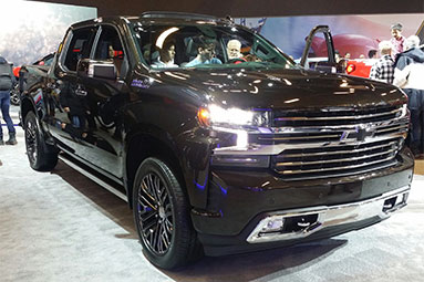 Front view of a black Chevrolet bakkie in a show room.