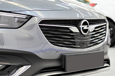 Close up of front grill of silver Opel Insignia.