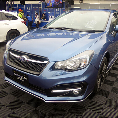 Side front view of a blue Subaru Impreza Hybrid Sport.