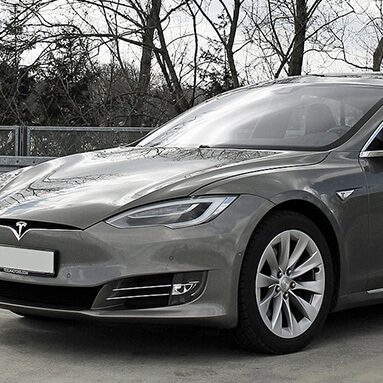 Front side view of a grey Tesla Model S.