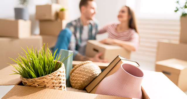 A couple in their new home which they could afford on the lower interest rate  