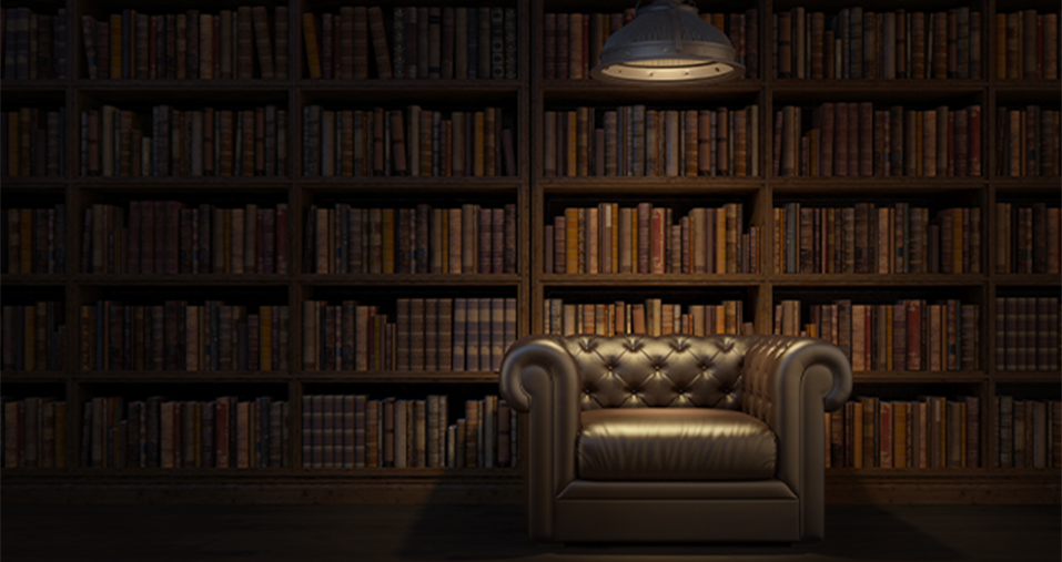 A leather chair in front of a bookshelf