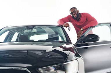 Man standing next to black Audi