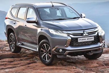 Front side view of a grey Mitsubishi Pajero Sport.