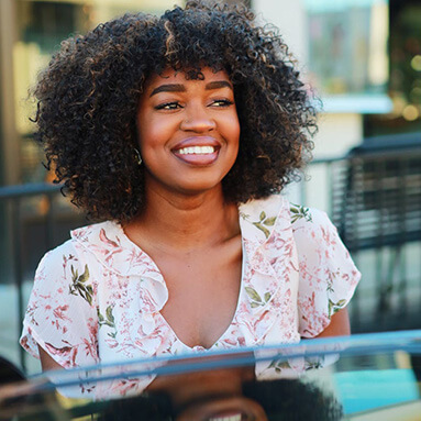 Smiling woman, wearing a white top