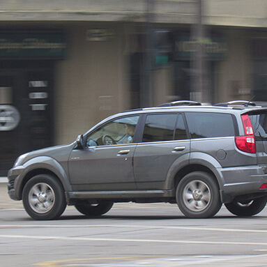 Side view of a grey 2011 Haval H3 on the road.