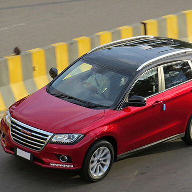 Top view of a red and black Haval H2 on the road.