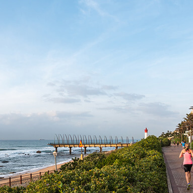 Durban coastline with woman jogging 