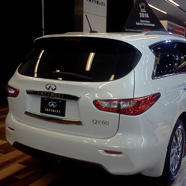Back view of the Infiniti QX60 in a showroom.