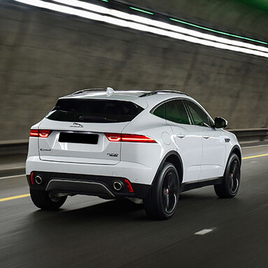 White Jaguar e-pace driving through a tunnel 