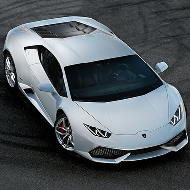 Top view of silver lamborghini Hurucán parked on racetrack.