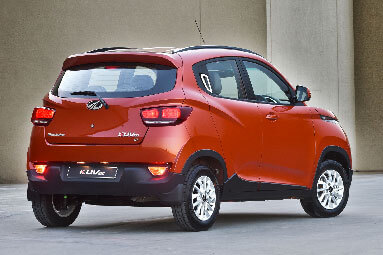 Side back view of a red Mahindra-KUV100-NXT