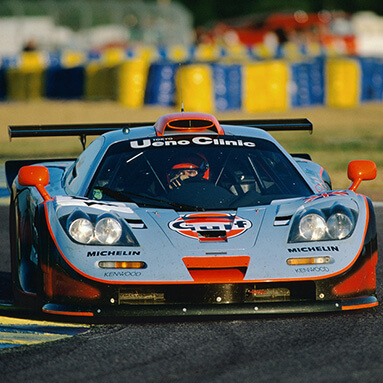 Grey and white McLaren F1 on the race course.