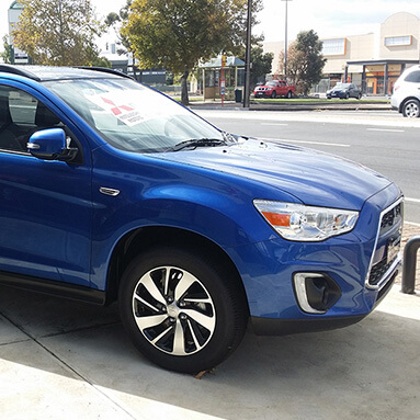 Front side view of a blue Mitsubishi ASX LS.