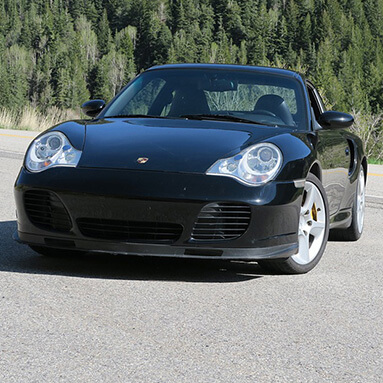 Black porsche parked facing in uphill