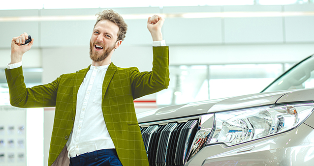 Happy car buyer jumping with keys