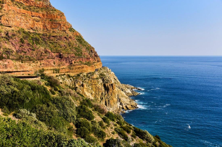 Green mountainside by the sea