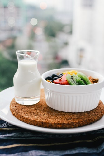 Milk jug next to fruit salad