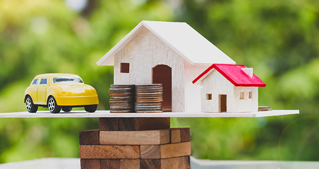 Toy car and toy houses illustrating how South Africans invest their savings