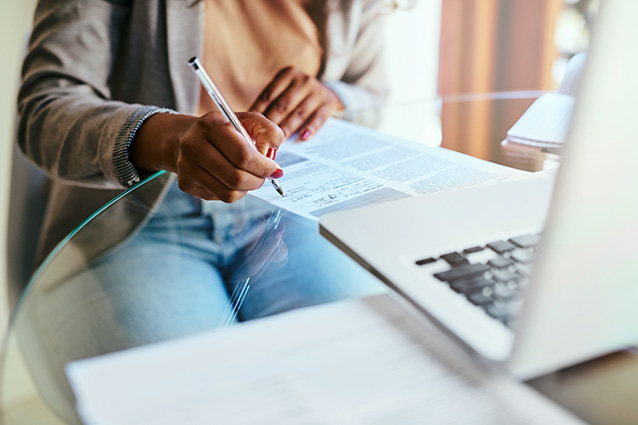 Woman sitting at a desk reviewing her Medical gap cover options