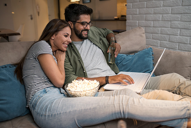 Couple watching a streaming video and making lockdown life easier with a better fibre deal