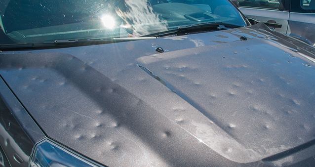 Hail-damaged car which needs to be paid for out of pocket if your car insurance was cancelled