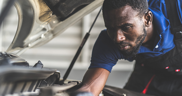 mechanic fixing car, showing that a high excess on your car insurance saves you money