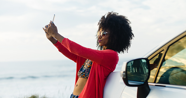 woman taking a selfie on a road trip