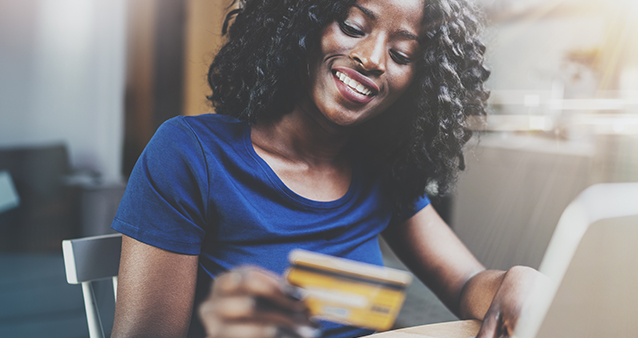 Happy woman manages her credit card debt