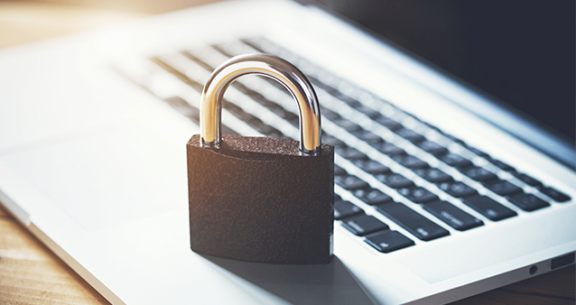 A lock sitting on a laptop keyboard