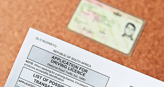 driver's licence and application form on desk