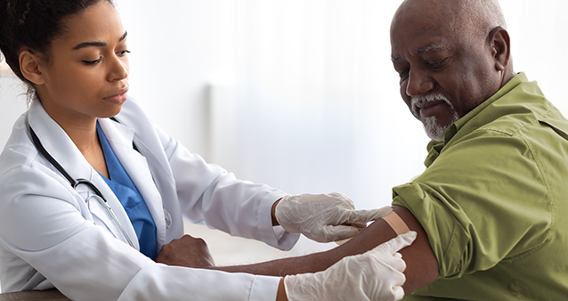 Nurse helping elderly gentleman