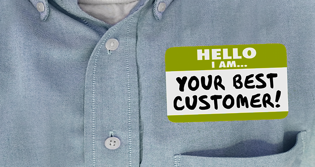 Customer wearing sticker 'Hello I am... Your best customer!'