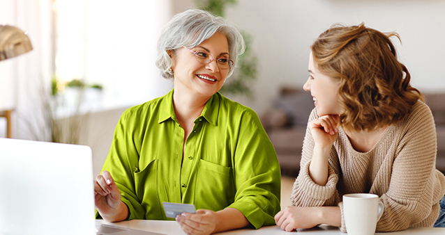 Older woman and younger woman discuss financial goals