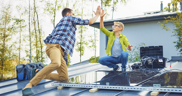 Two men installing solar panels