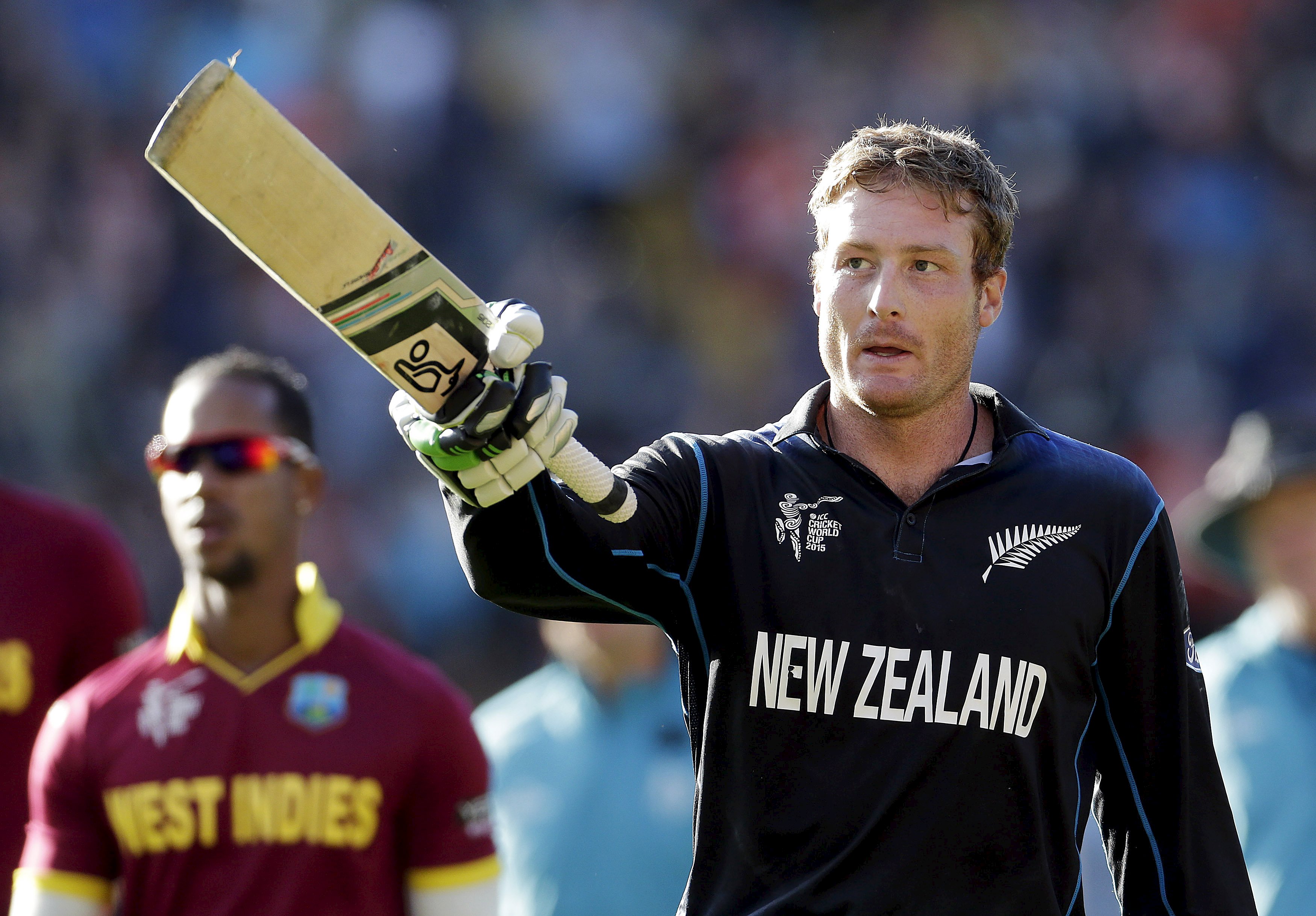 New Zealand batsman holding up a bat.