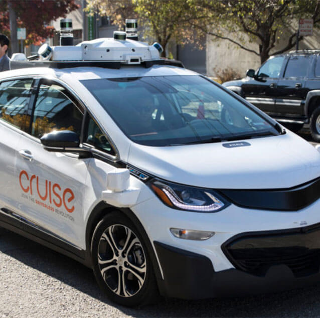 Front side view of an autonomous Chevrolet Bolt electric car.