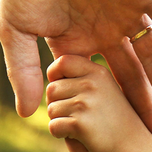 Child holding mans hand