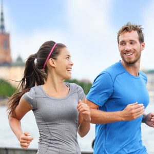 Couple jogging together smiling 