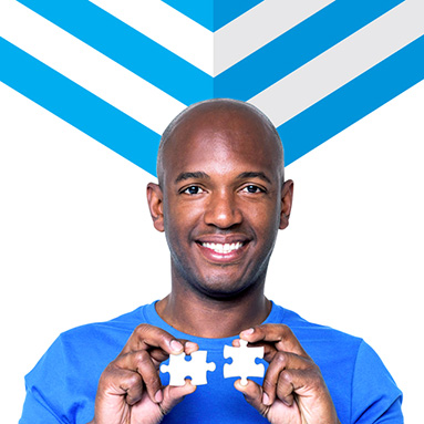 Man smiling holding a puzzle piece in each hand next to each other indicating that they fit | Budget beaters | Hippo partner