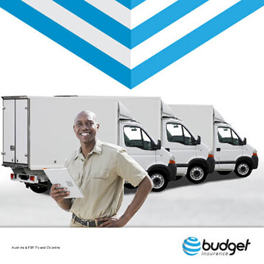 Man with clipboard in hand standing in front of 3 delivery vehicles
