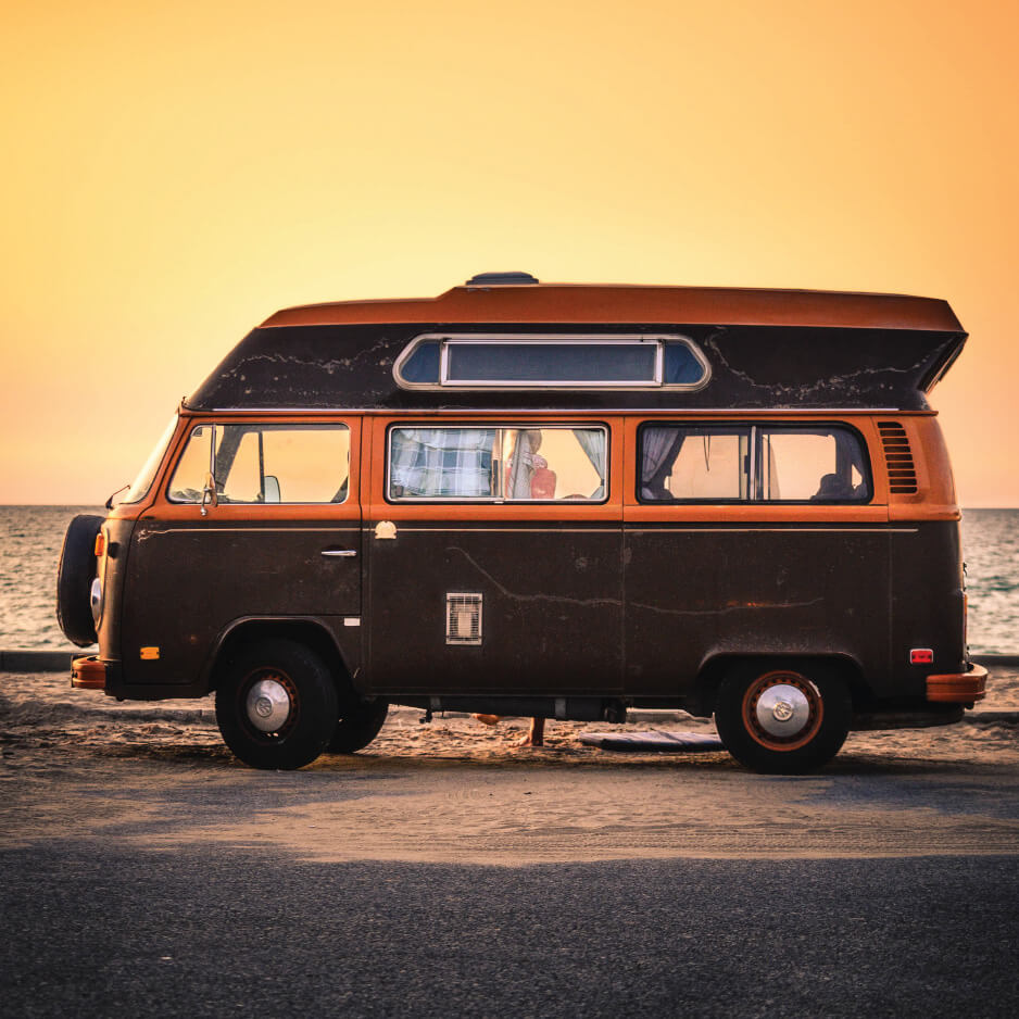 Family caravan parked on beach during sunset