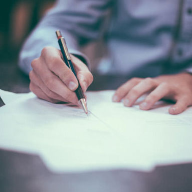 Man signing documents with ball point pen 