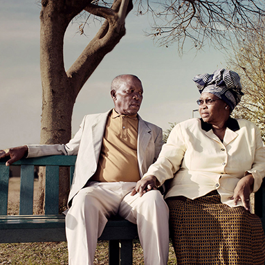 Elderly couple sitting under a tree | History of Stangen | Hippo.co.za partner