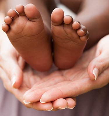 baby feet in hands 