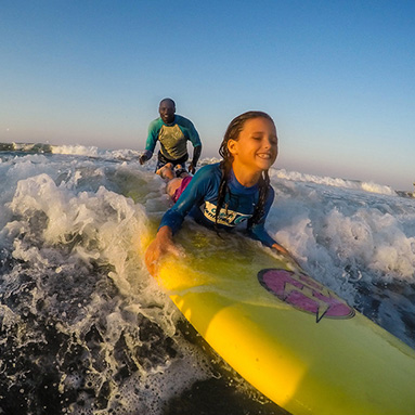 Girl learning how to surf at Addington Beach, Durban.