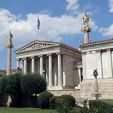 Academy of Athens with cloudy sky in the background.