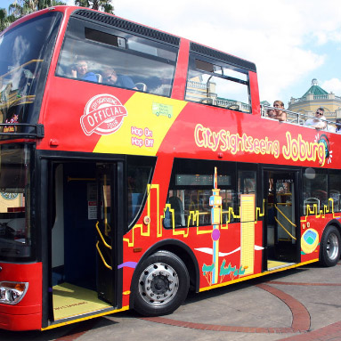 A red Johannesburg tour bus