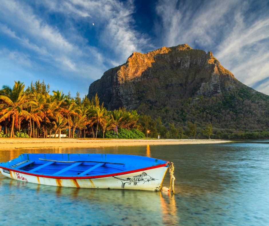 Airplane wing with sea and cloudy sky in the background.