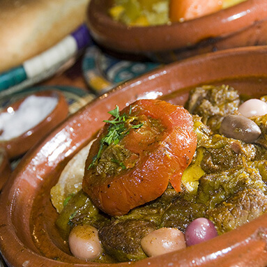 Traditional Moroccan meat dish with bright red tomato, onions and meat